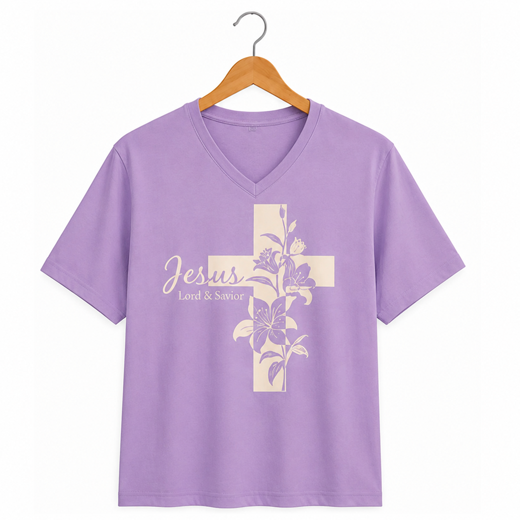 Jesus Lily Cross cream floral cross design on a lavender v-neck t-shirt hanging on a wooden hanger.