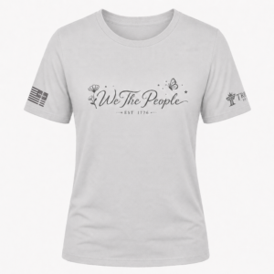 Silver We the People crew neck shirt with gray script design, floral artwork, butterfly, and EST 1776.