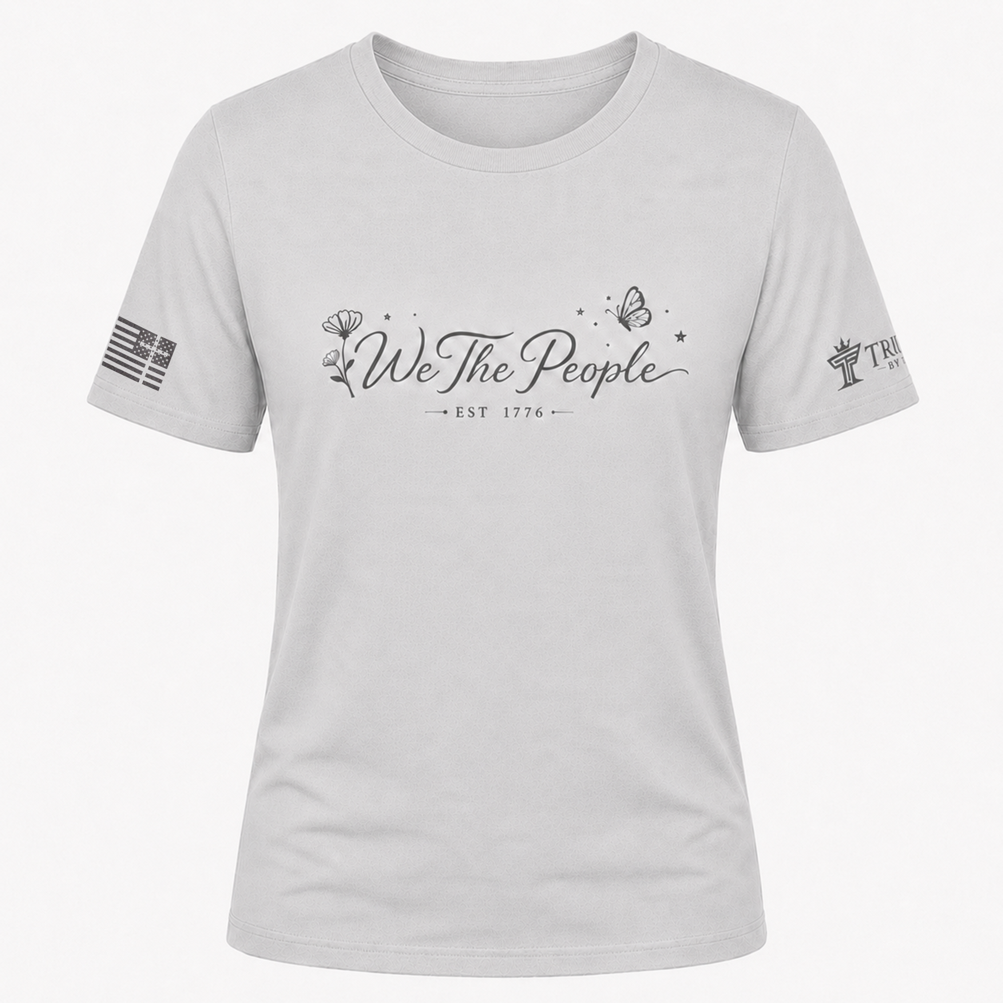 Silver We the People crew neck shirt with gray script design, floral artwork, butterfly, and EST 1776.