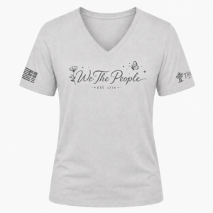 Silver We the People V-neck shirt with gray floral script design, butterfly accents, and EST 1776.