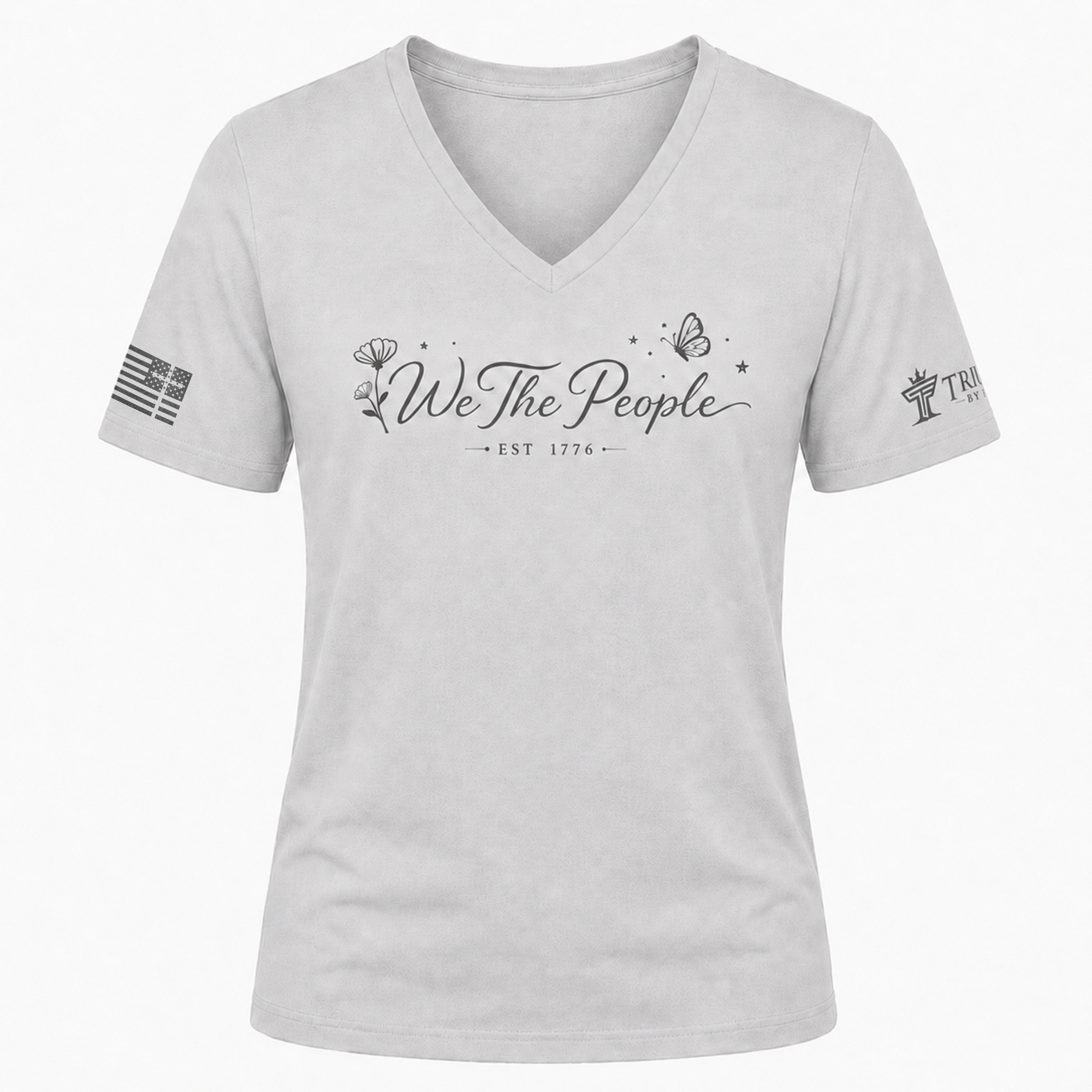 Silver We the People V-neck shirt with gray floral script design, butterfly accents, and EST 1776.