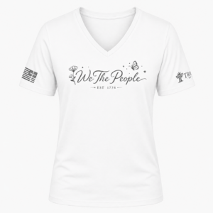 White We the People V-neck shirt with gray script lettering, flower artwork, butterfly, and EST 1776.