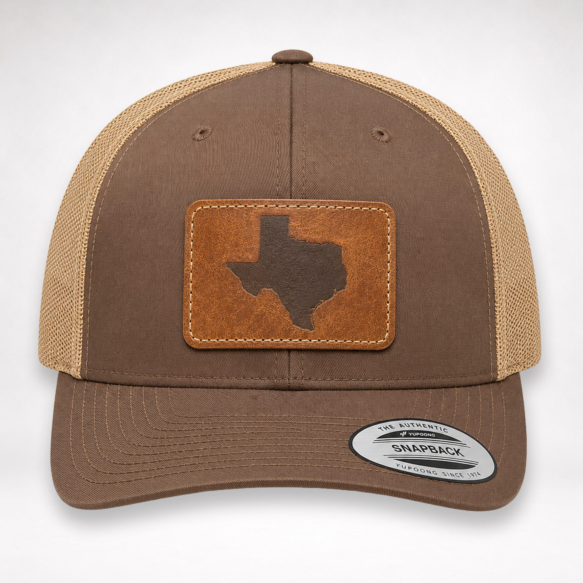 Front view of Texas Engraved Patch Trucker Hat with brown front panels, khaki mesh, and leather-style Texas patch.