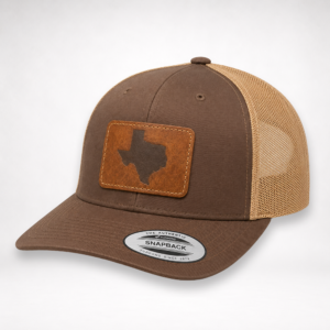 Side angle view of Texas Engraved Patch Trucker Hat showing brown crown, khaki mesh, and engraved patch.